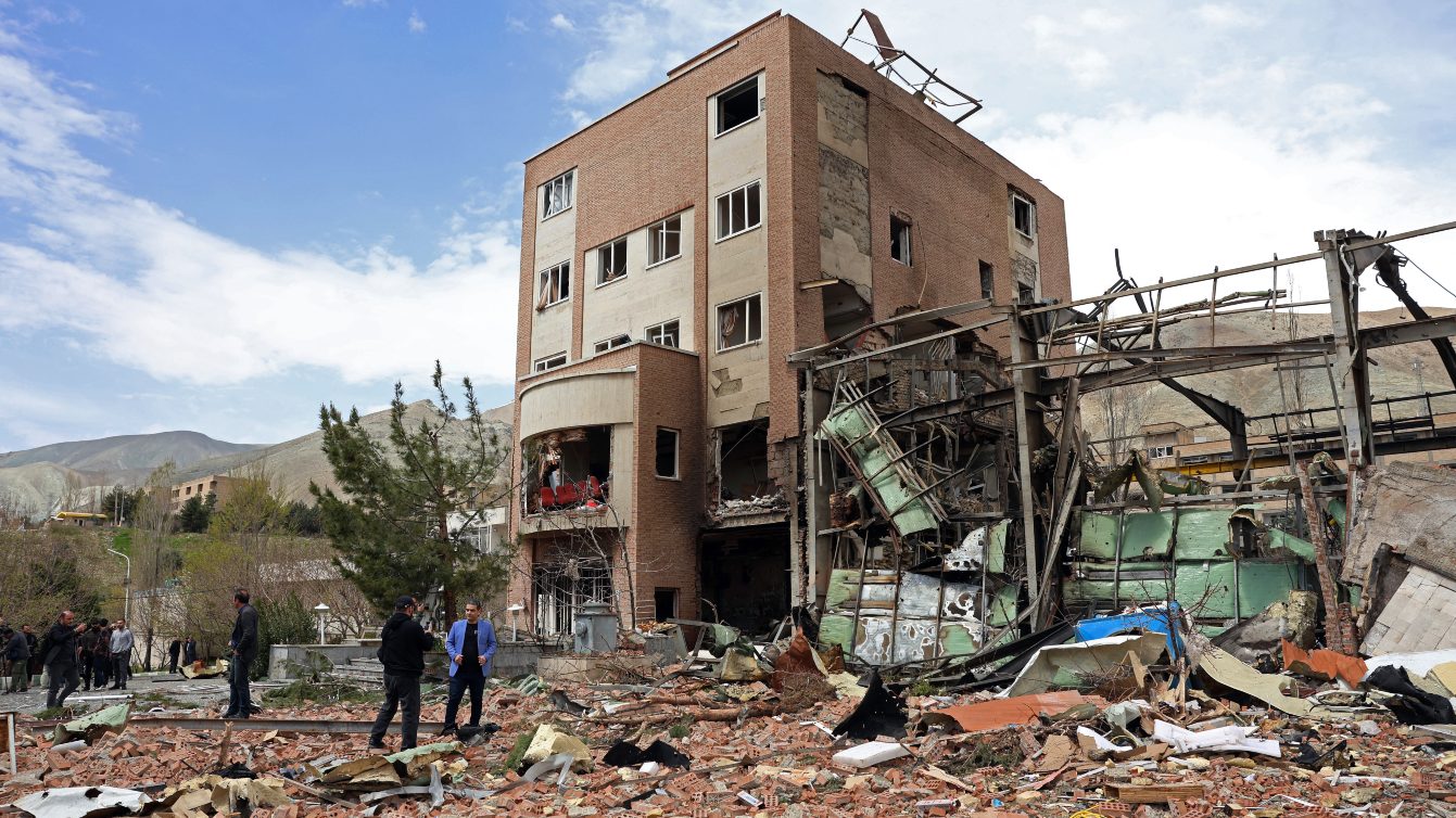 Officials and press gather around the damaged building of the Shahid Beheshti University following a strike, in Tehran on 4 April 2026. AFP